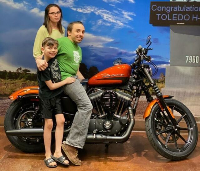 Hilarious Viral Dealership Photo Shows Smiling Husband, Scowling Wife