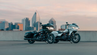 A set of 2024 Harley-Davidson CVO Road Glides parked in front of a skyline.